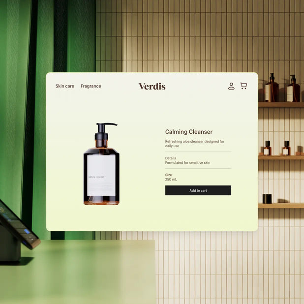 The interior of a retail store. In the foreground is the sales counter; in the background, three shelves holding skincare products. Over the scene is a browser window containing the store's website, indicating the products are for sale in store and online.